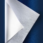 In-line laminate technology utilizing polyester nonwoven laminate on PVC film to provide a soft feel that aids in patient comfort.